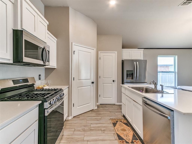 3721 Central Park Dr, Moore, OK 73160 - kitchen with stainless steel appliances, a sink, light wood-type flooring, tasteful backsplash, and light countertops