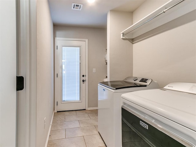 3721 Central Park Dr, Moore, OK 73160 - clothes washing area with separate washer and dryer, light tile patterned flooring, baseboards, and healthy amount of natural light