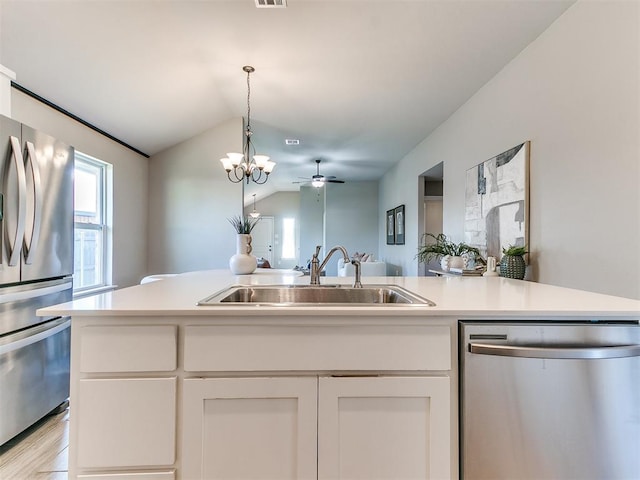 3721 Central Park Dr, Moore, OK 73160 - kitchen with appliances with stainless steel finishes, a sink, lofted ceiling, open floor plan, and white cabinets
