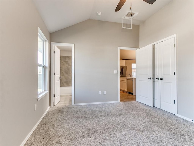 3721 Central Park Dr, Moore, OK 73160 - unfurnished bedroom featuring carpet floors, baseboards, lofted ceiling, multiple windows, and connected bathroom