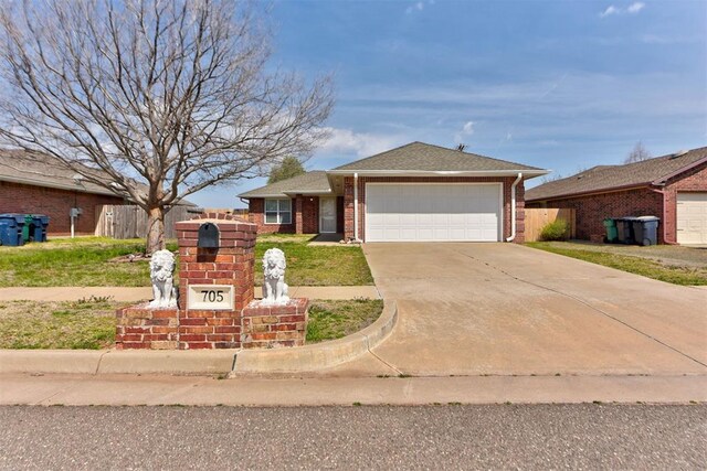 705 NE 85th St, Oklahoma City, OK 73114 - ranch-style house with fence, a garage, concrete driveway, brick siding, and a shingled roof