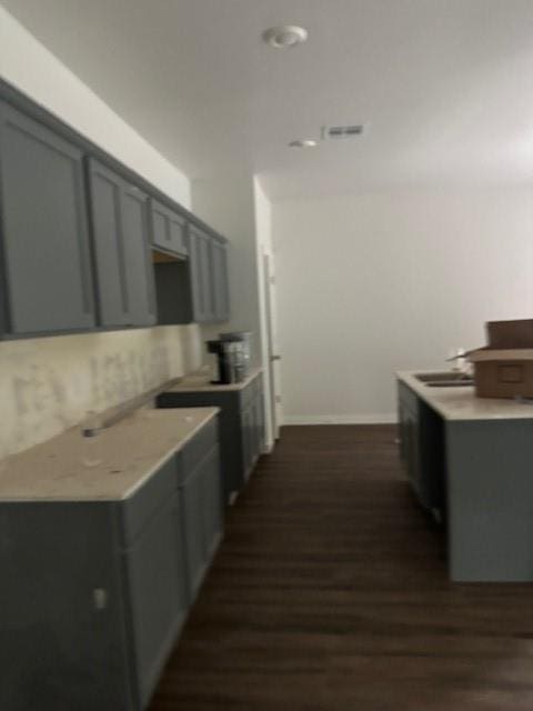 11767 Sweeping Ln, Guthrie, OK 73044 - kitchen with dark wood-style floors, gray cabinets, and light countertops