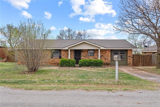 1316 D St, Arapaho, OK 73620 - ranch-style home with brick siding, a shingled roof, fence, and a front lawn