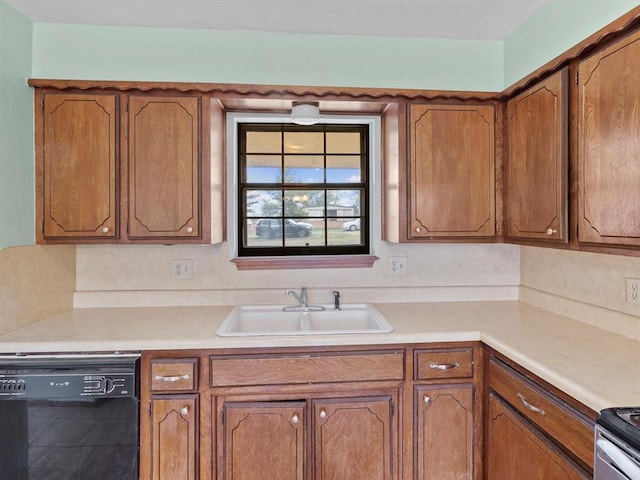 kitchen with black dishwasher, brown cabinets, light countertops, and a sink
