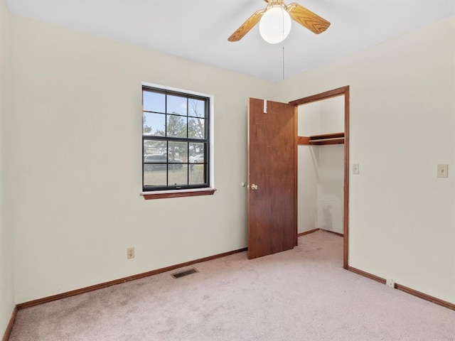unfurnished bedroom with a closet, visible vents, baseboards, a ceiling fan, and carpet floors