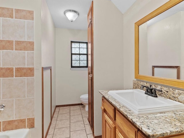 full bathroom featuring toilet, vanity, baseboards, and tile patterned flooring