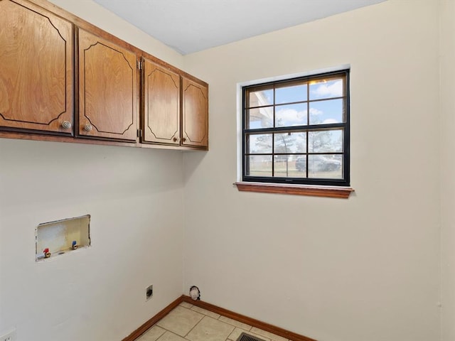 laundry room featuring light tile patterned floors, hookup for a washing machine, baseboards, cabinet space, and electric dryer hookup