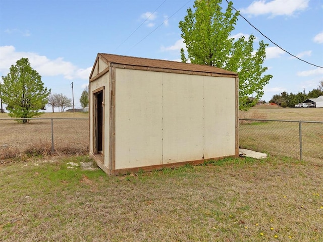 view of shed featuring fence