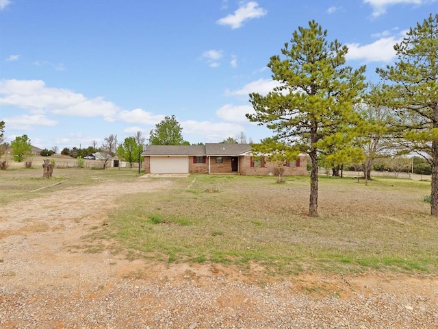 exterior space with dirt driveway and a garage