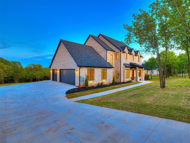 view of front of property featuring concrete driveway, a front lawn, and brick siding