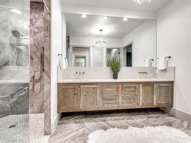 bathroom featuring a shower with door, double vanity, marble finish floor, and a notable chandelier