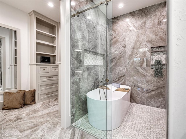full bath featuring marble finish floor, built in features, a freestanding bath, a walk in shower, and recessed lighting