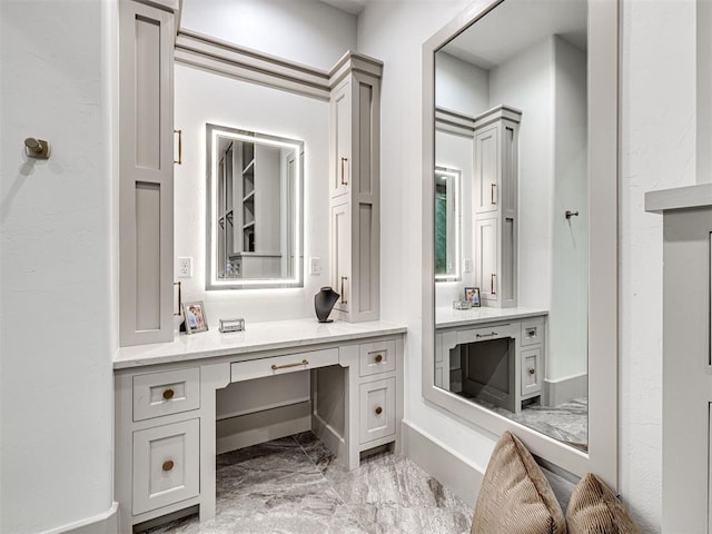 bathroom with marble finish floor and vanity
