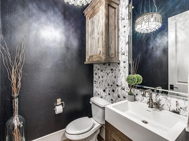 half bath featuring vanity and toilet