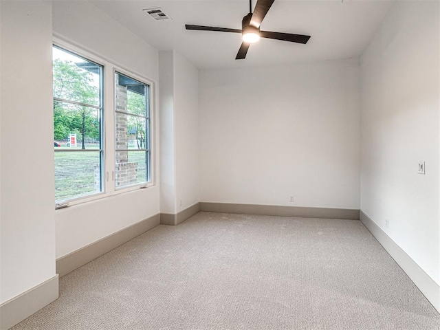 unfurnished room featuring light carpet, visible vents, and plenty of natural light