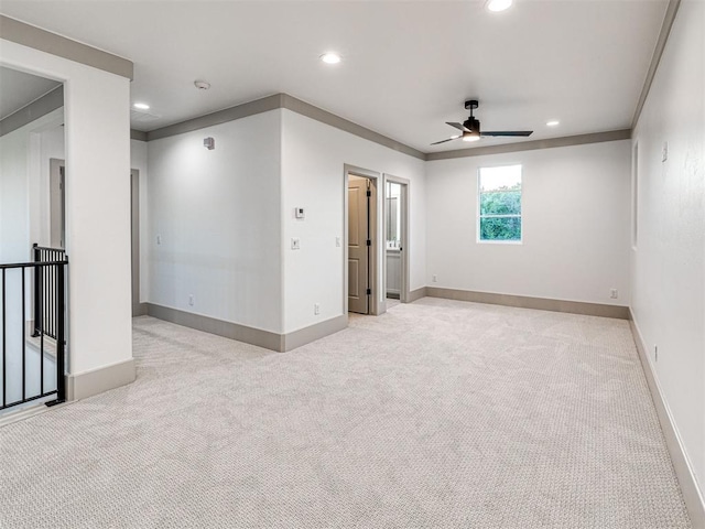 spare room with recessed lighting, a ceiling fan, and carpet