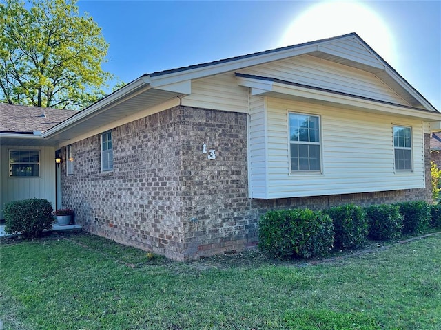 view of side of property with a yard