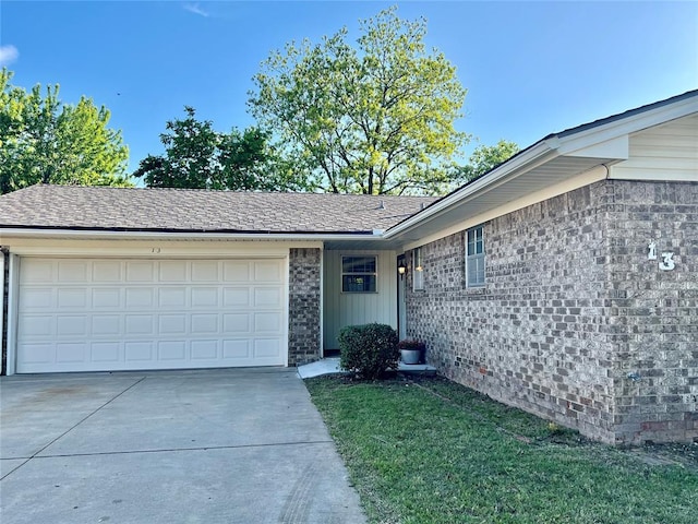 single story home featuring a garage, driveway, and a front lawn