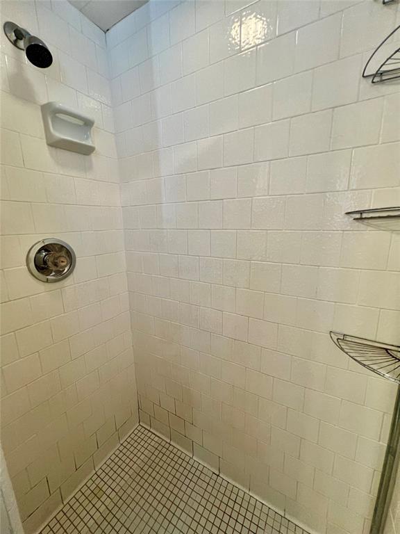 bathroom with tiled shower
