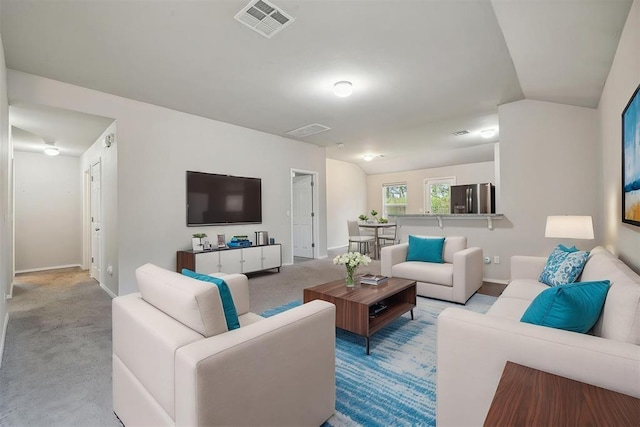 carpeted living room featuring visible vents and baseboards
