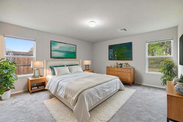 bedroom with carpet flooring, visible vents, and baseboards