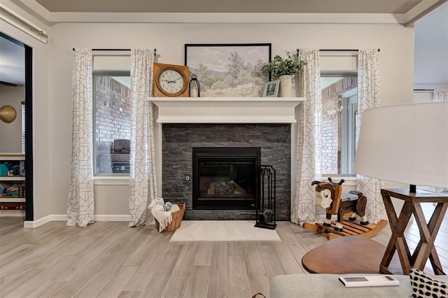 living area with wood finished floors, a fireplace, and a wealth of natural light