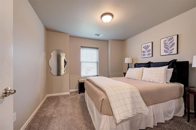 carpeted bedroom featuring visible vents and baseboards