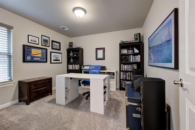 office space with visible vents, baseboards, carpet floors, and a healthy amount of sunlight