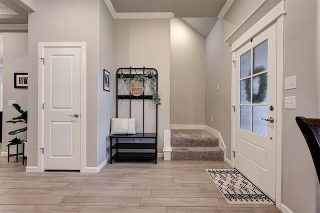 entrance foyer with baseboards and light wood-style floors