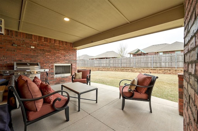 view of patio / terrace with a fenced backyard, a grill, and outdoor lounge area