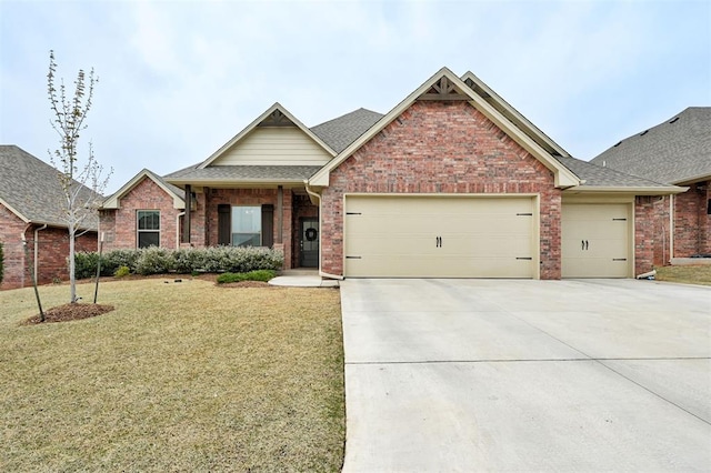 view of front of home with brick siding, an attached garage, a front lawn, and concrete driveway