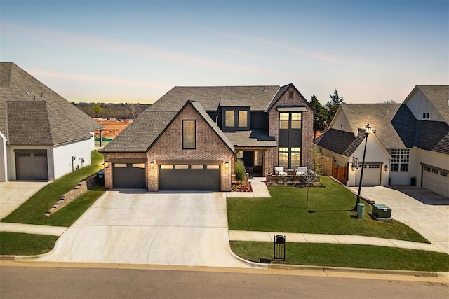 3824 Stone Hill Ln, Edmond, OK 73034 - view of front of house with brick siding, driveway, and a front lawn