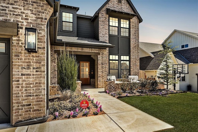 3824 Stone Hill Ln, Edmond, OK 73034 - view of front of house with brick siding, a front lawn, and a shingled roof