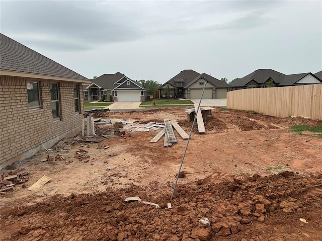 view of yard with fence and a residential view