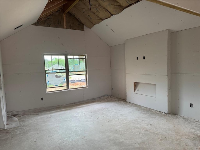 unfurnished living room with vaulted ceiling
