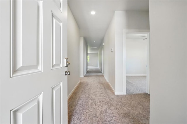 corridor featuring carpet flooring, recessed lighting, and baseboards