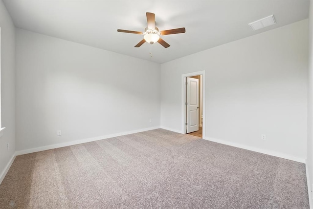 empty room with ceiling fan, baseboards, and carpet
