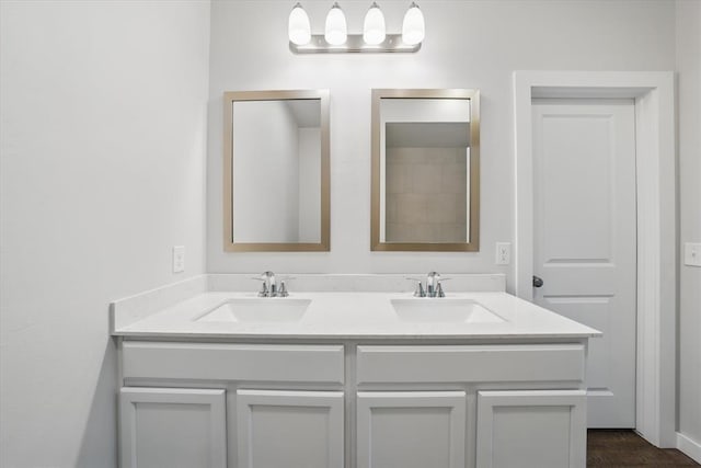 bathroom with a sink and double vanity