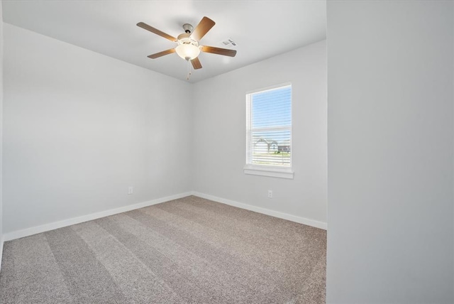 unfurnished room with baseboards, ceiling fan, carpet flooring, and visible vents