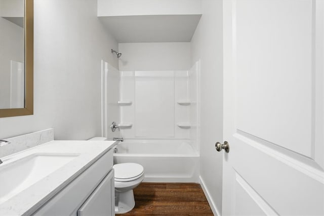 bathroom featuring vanity, wood finished floors, bathing tub / shower combination, and toilet