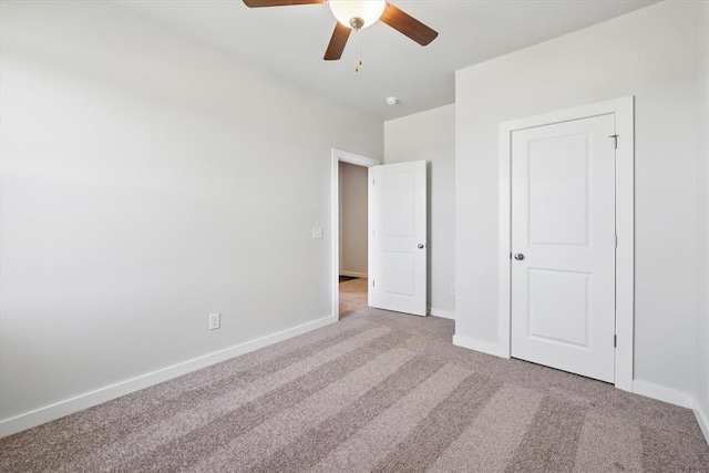 unfurnished bedroom featuring baseboards, a ceiling fan, and carpet flooring