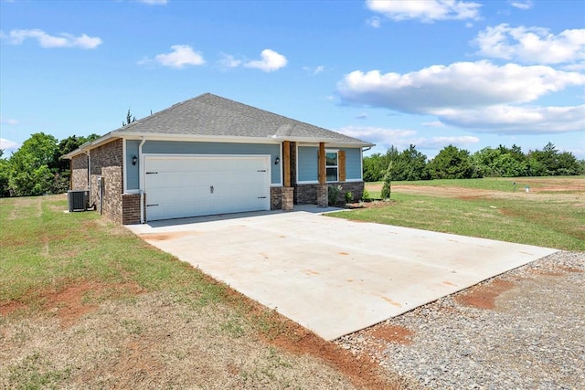 view of front of property with an attached garage, brick siding, a front yard, cooling unit, and driveway