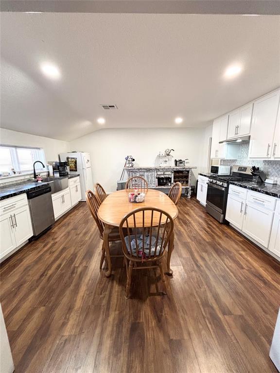 9737 NE State Highway 15, Shattuck, OK 32911 - dining space featuring recessed lighting, dark wood-style floors, vaulted ceiling, and visible vents