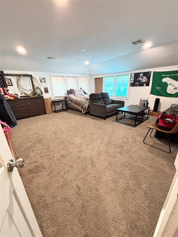 9737 NE State Highway 15, Shattuck, OK 32911 - bedroom with carpet flooring, vaulted ceiling, and visible vents