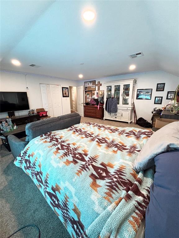 9737 NE State Highway 15, Shattuck, OK 32911 - bedroom with lofted ceiling, visible vents, recessed lighting, and carpet
