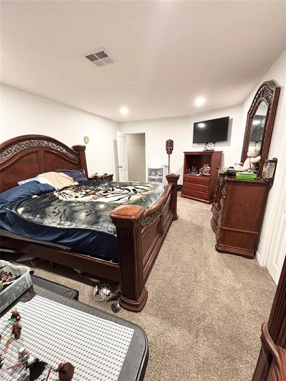 9737 NE State Highway 15, Shattuck, OK 32911 - bedroom with recessed lighting, light carpet, and visible vents