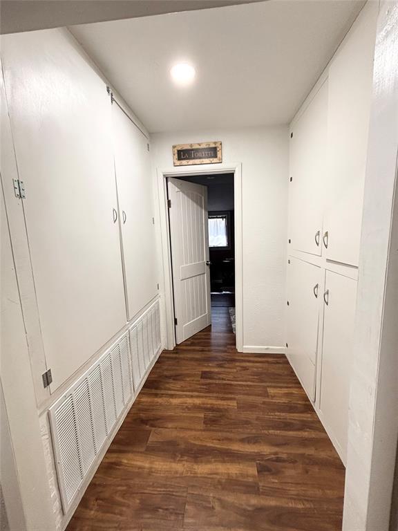 9737 NE State Highway 15, Shattuck, OK 32911 - corridor with dark wood-type flooring and visible vents