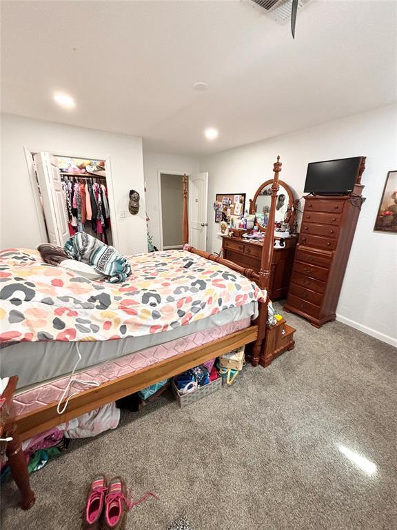 9737 NE State Highway 15, Shattuck, OK 32911 - bedroom featuring baseboards, recessed lighting, a closet, and carpet