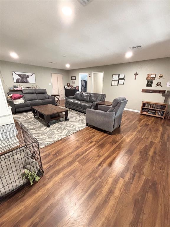 9737 NE State Highway 15, Shattuck, OK 32911 - living area with baseboards, visible vents, and wood finished floors