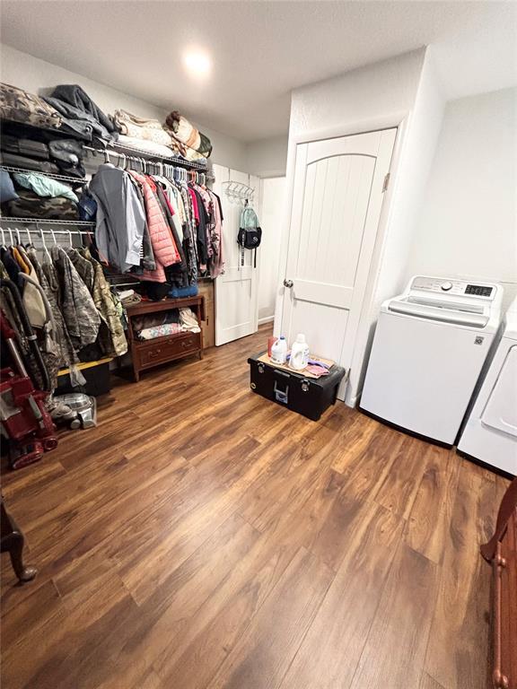 9737 NE State Highway 15, Shattuck, OK 32911 - spacious closet featuring washer and clothes dryer and wood finished floors